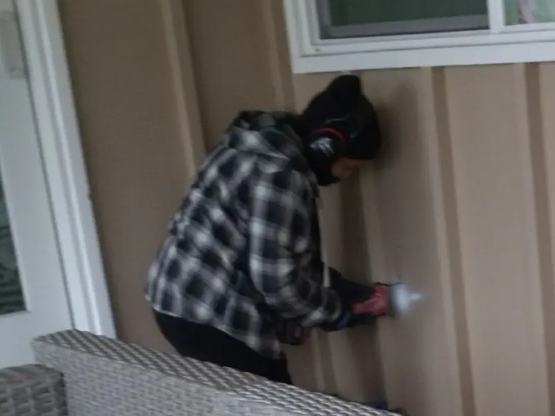 Professional electrician installing an exterior outlet in Ambridge